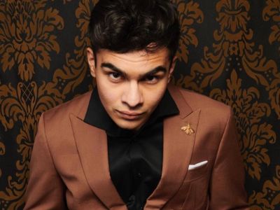 Sauriyan Sapkota is wearing a brown suit in the picture.